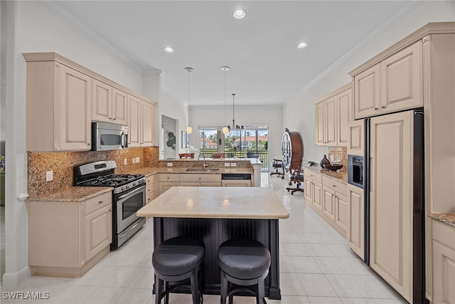 kitchen featuring hanging light fixtures, kitchen peninsula, a kitchen island, stainless steel appliances, and crown molding