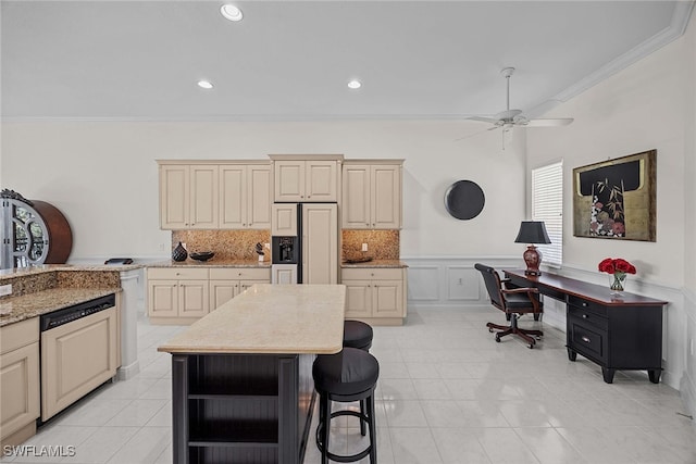 kitchen with cream cabinets, ornamental molding, dishwashing machine, and a center island