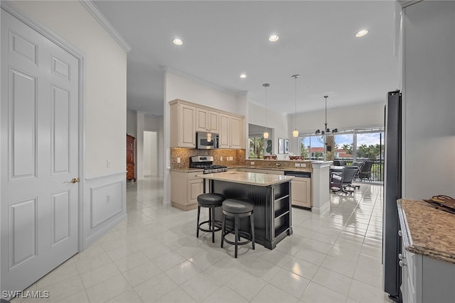 kitchen with pendant lighting, a kitchen island, stainless steel appliances, kitchen peninsula, and a kitchen bar