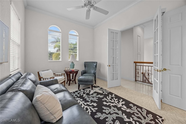 carpeted living room featuring ceiling fan, crown molding, and plenty of natural light