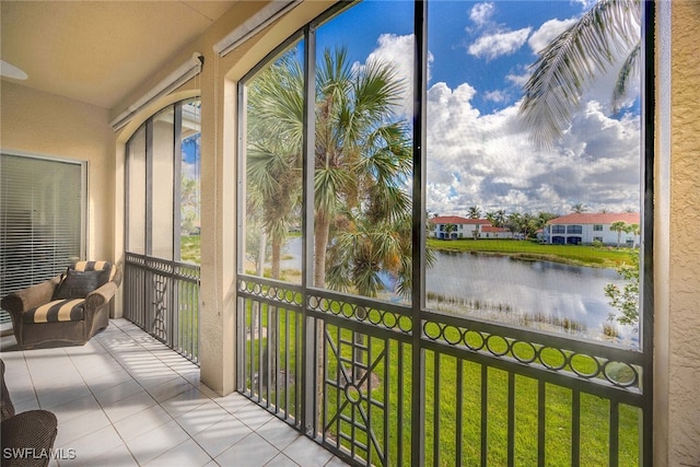 sunroom featuring a water view and a wealth of natural light