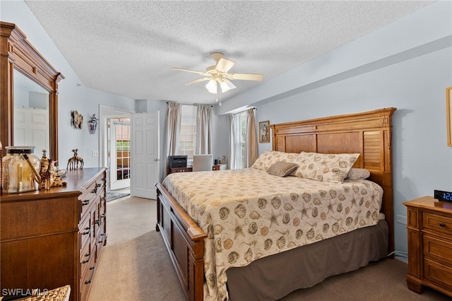 carpeted bedroom featuring a textured ceiling, access to exterior, and ceiling fan