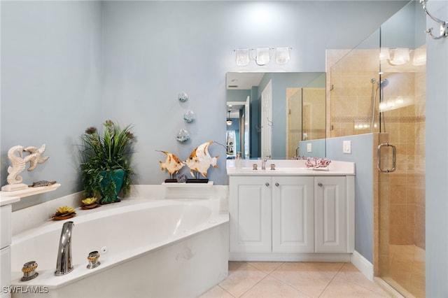 bathroom with tile patterned floors, vanity, and separate shower and tub