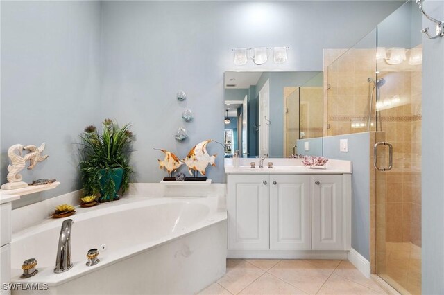 9235 Tesoro Ln Unit 4-102, Naples, FL 34114 - bathroom featuring a shower stall, a garden tub, vanity, and tile patterned flooring