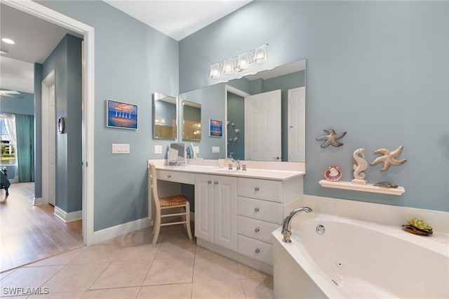 bathroom featuring tile patterned floors, ceiling fan, a bath, and vanity