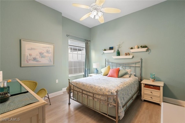 9235 Tesoro Ln Unit 4-102, Naples, FL 34114 - bedroom with baseboards, a ceiling fan, and wood finished floors