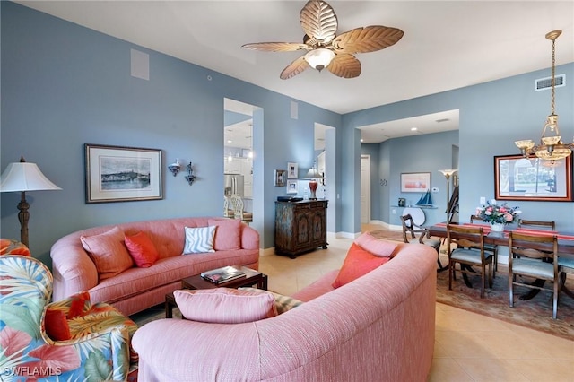 9235 Tesoro Ln Unit 4-102, Naples, FL 34114 - living area with light tile patterned floors, visible vents, and ceiling fan with notable chandelier