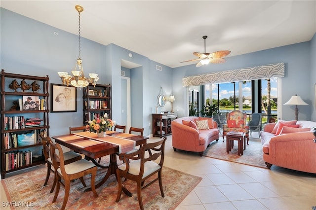 tiled dining area featuring ceiling fan with notable chandelier