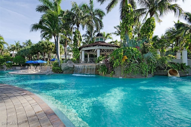 view of swimming pool with a gazebo and pool water feature