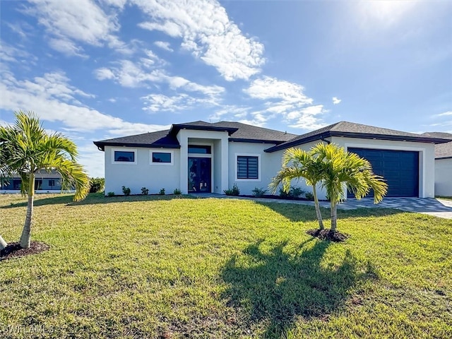 view of front of home with a garage and a front yard