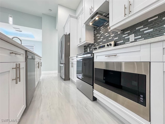 kitchen with white cabinets, stainless steel appliances, and backsplash