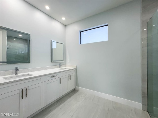 bathroom featuring vanity and a shower with door