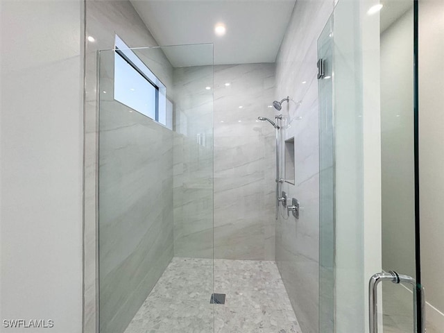 bathroom with a shower with door