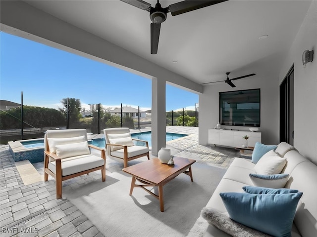 view of patio / terrace with ceiling fan and a swimming pool with hot tub