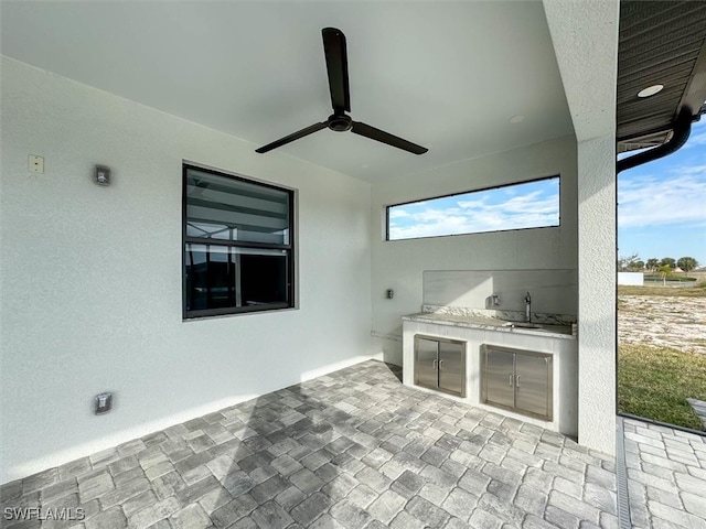 view of patio / terrace with exterior kitchen and ceiling fan