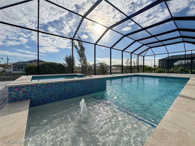 view of pool featuring a patio, glass enclosure, and an in ground hot tub