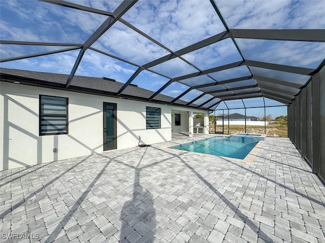 view of swimming pool featuring a patio and a lanai