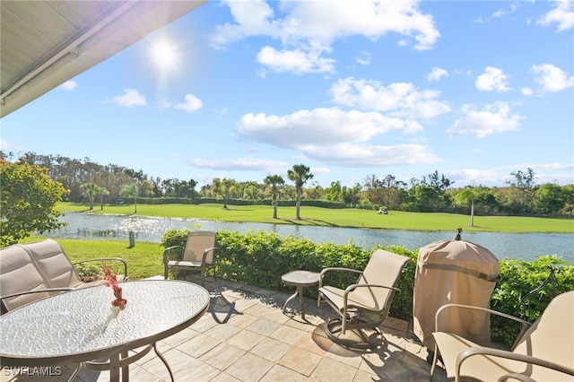 view of patio / terrace featuring a water view and a grill