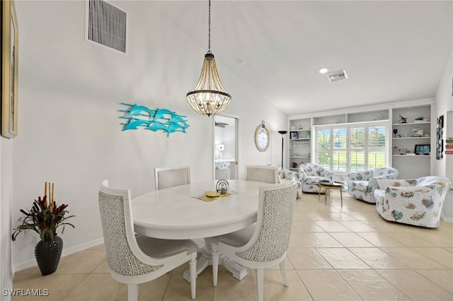 dining room featuring lofted ceiling, light tile patterned flooring, an inviting chandelier, and built in features