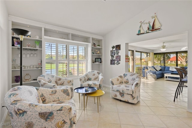 living room with vaulted ceiling, ceiling fan, and light tile patterned flooring