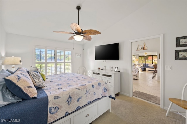 carpeted bedroom featuring ceiling fan and vaulted ceiling