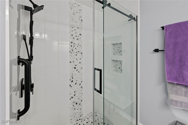 bathroom with a shower with door