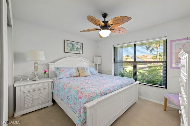 bedroom with ceiling fan and light colored carpet