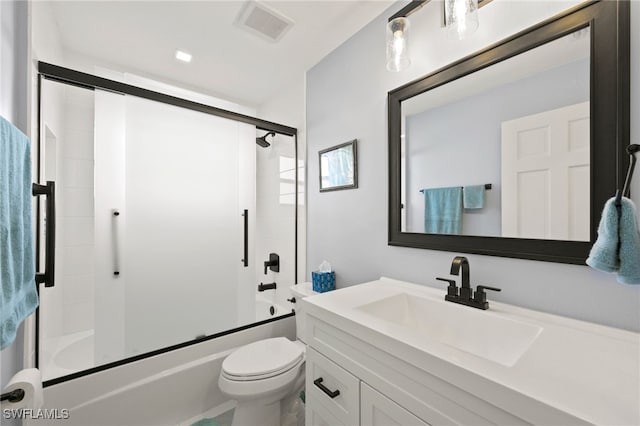 full bathroom featuring bath / shower combo with glass door, vanity, and toilet