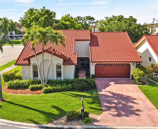 view of front of house featuring a garage and a front lawn