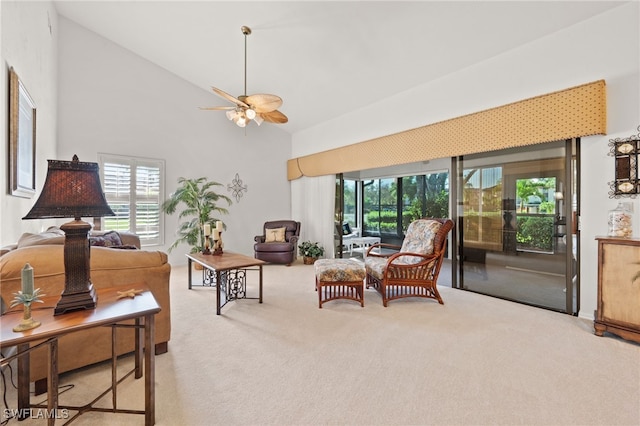 living room featuring light carpet, high vaulted ceiling, and ceiling fan