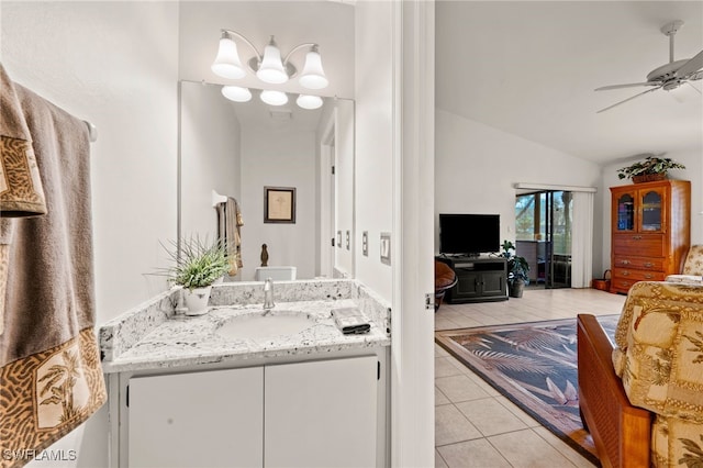 bathroom with ceiling fan, vanity, tile patterned flooring, and vaulted ceiling