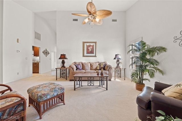 carpeted living room featuring ceiling fan and high vaulted ceiling