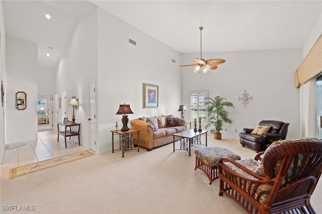 living room featuring light colored carpet, high vaulted ceiling, and ceiling fan