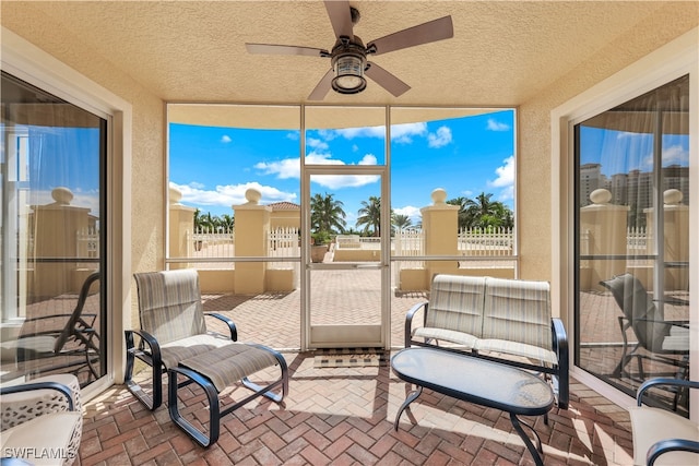 sunroom / solarium featuring ceiling fan