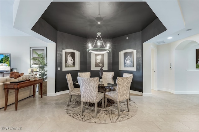 dining space with a chandelier and light tile patterned floors