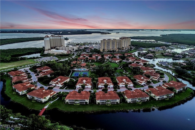 aerial view at dusk with a water view