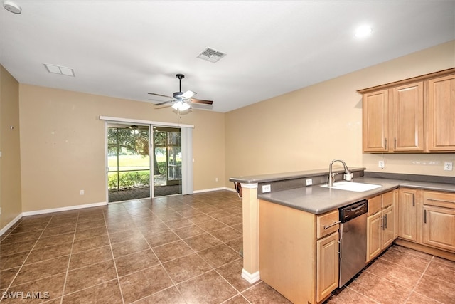 kitchen featuring ceiling fan, sink, kitchen peninsula, dark tile patterned floors, and stainless steel dishwasher