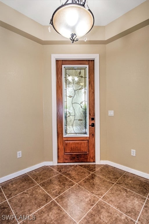 foyer entrance featuring dark tile patterned flooring