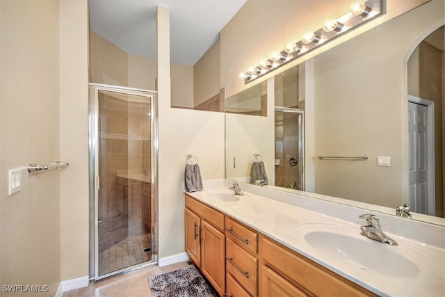 bathroom with tile patterned flooring, vanity, and an enclosed shower