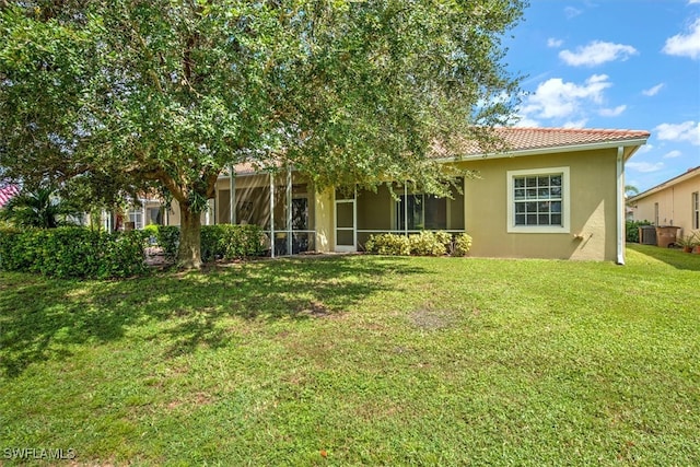 rear view of house featuring a yard