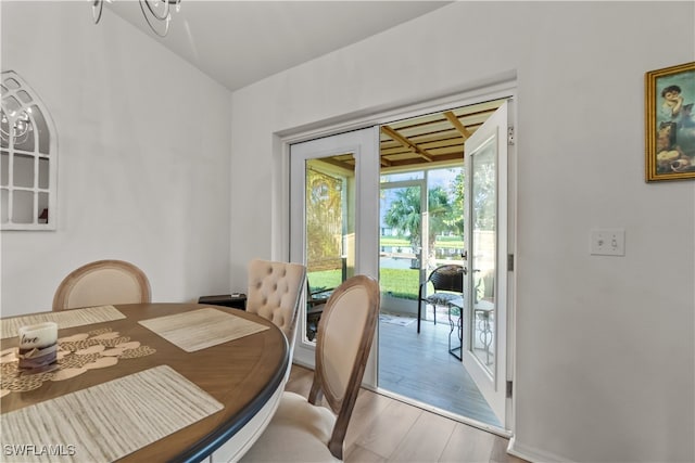 dining room with hardwood / wood-style flooring and a notable chandelier