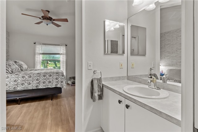 bathroom featuring ceiling fan, vanity, and wood-type flooring