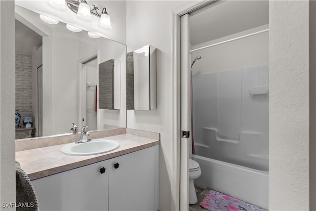 full bathroom featuring vanity, tiled shower / bath combo, and toilet