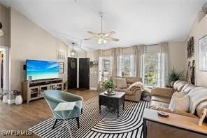 living room featuring ceiling fan, dark wood-type flooring, and vaulted ceiling