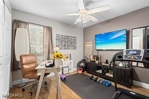 workout area with ceiling fan and hardwood / wood-style flooring