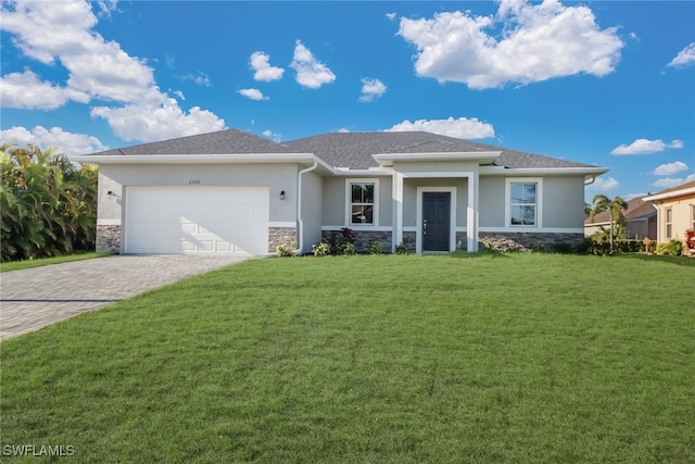 view of front of home with a front yard and a garage