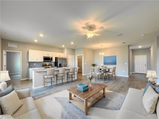 living room with ceiling fan and light hardwood / wood-style floors