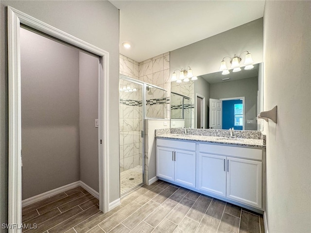 bathroom with vanity and a shower with shower door