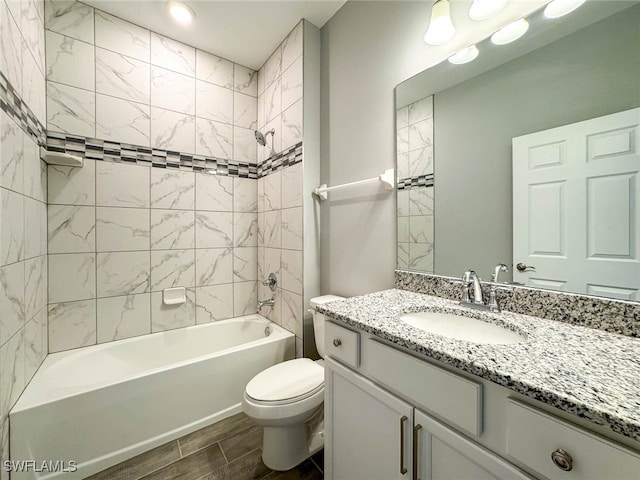 full bathroom with vanity, toilet, and tiled shower / bath