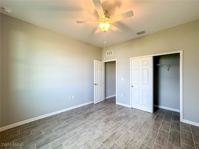 unfurnished bedroom with ceiling fan, a closet, and wood-type flooring